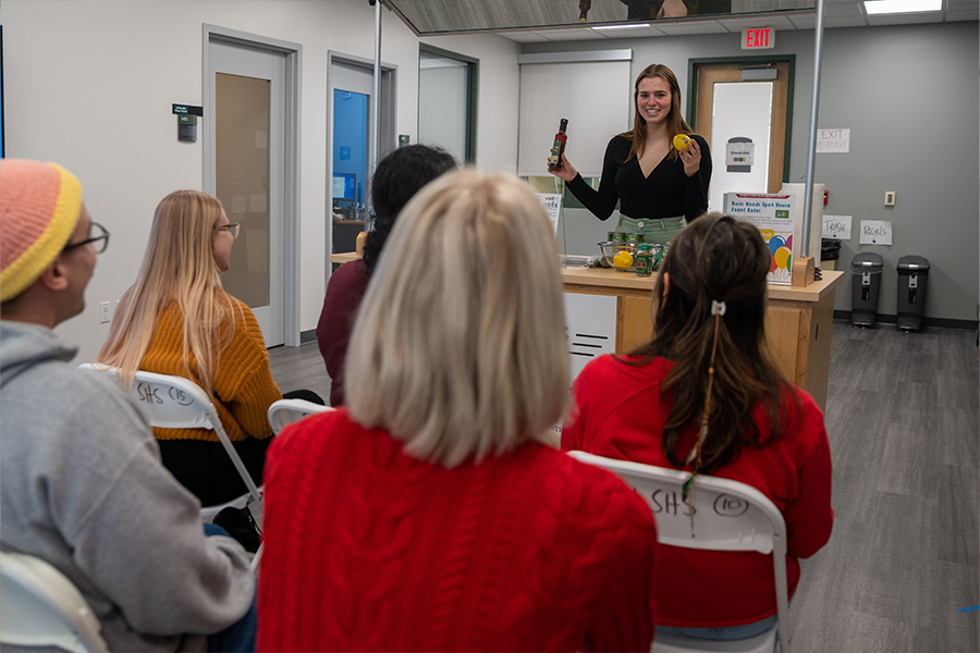person with food at a cart giving a presentation